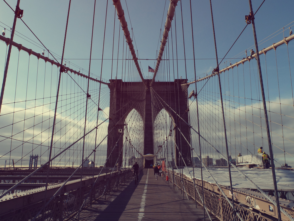 A bike rider on the Brooklyn Bridge in NYC.