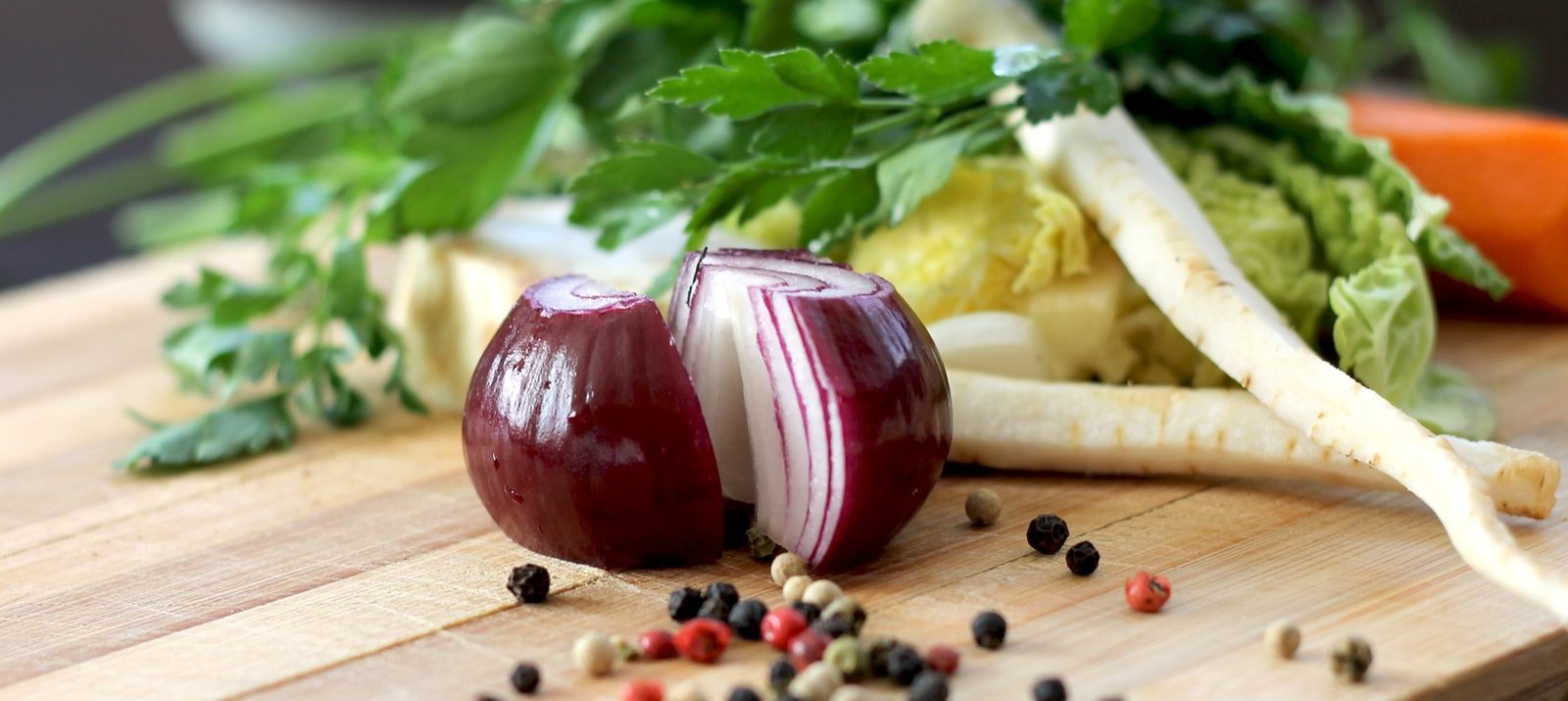 vegetables on a cutting board for cooking in a small kitchen