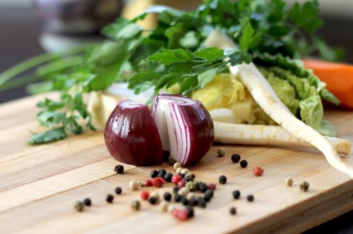 vegetables on a cutting board for cooking in a small kitchen