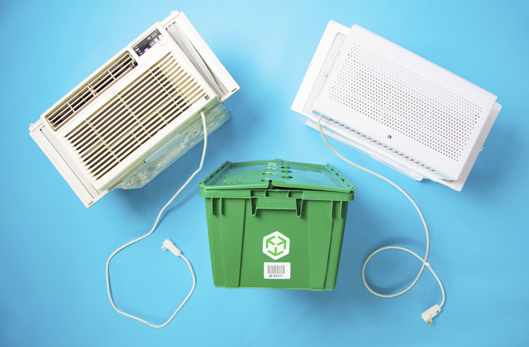 A MakeSpace storage bin is surrounded by two window air conditioners.