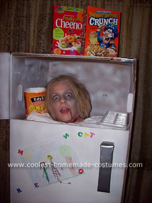 A girl wearing a scary frozen head in fridge Halloween costume.