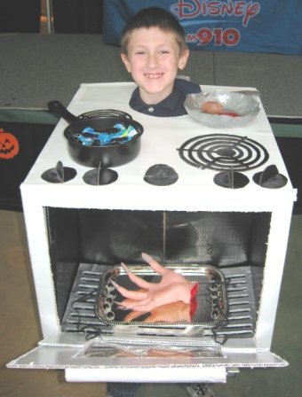 A boy is wearing an oven Halloween costume.