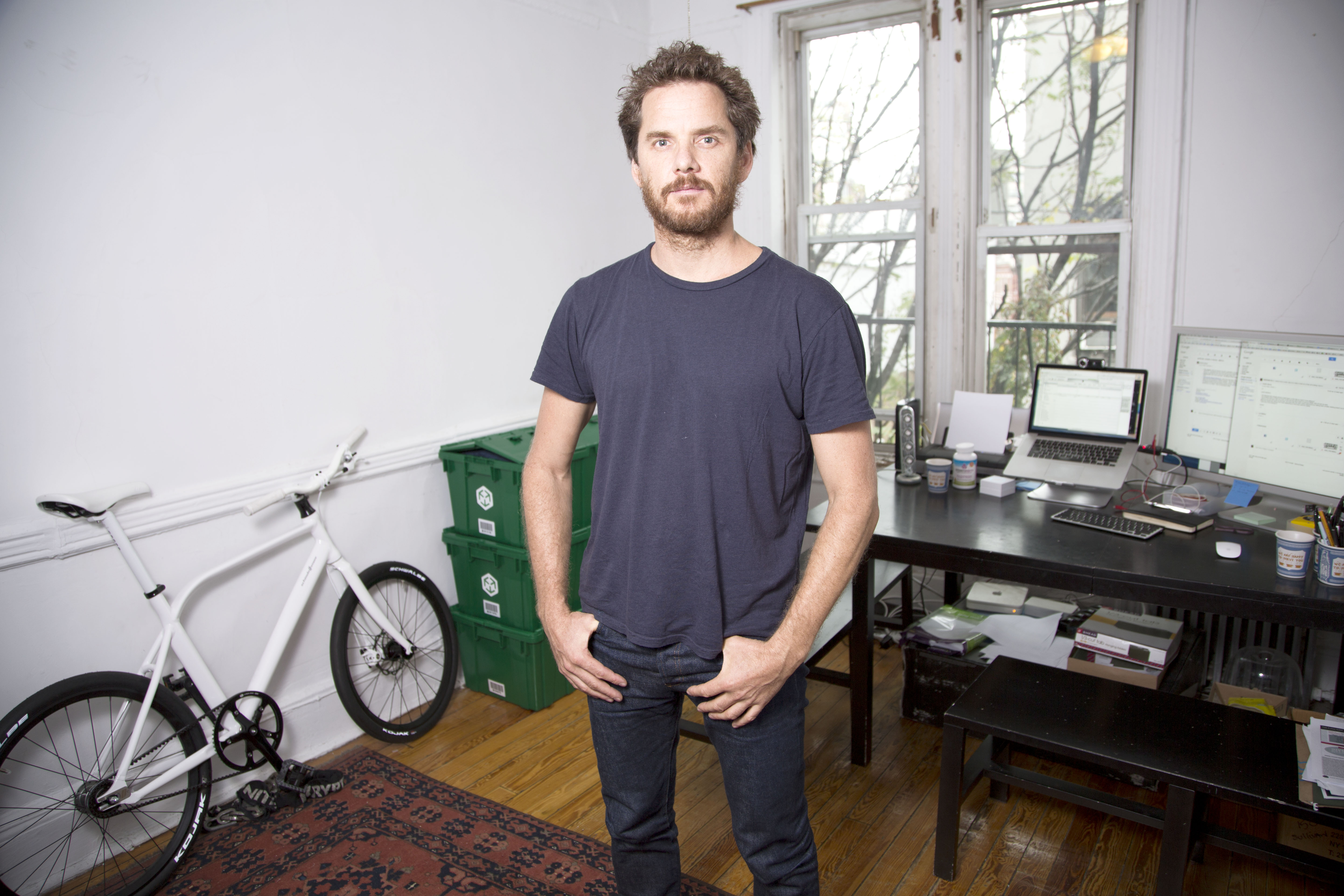 Graham Hill standing inside of his new NYC micro-studio that he's restoring.