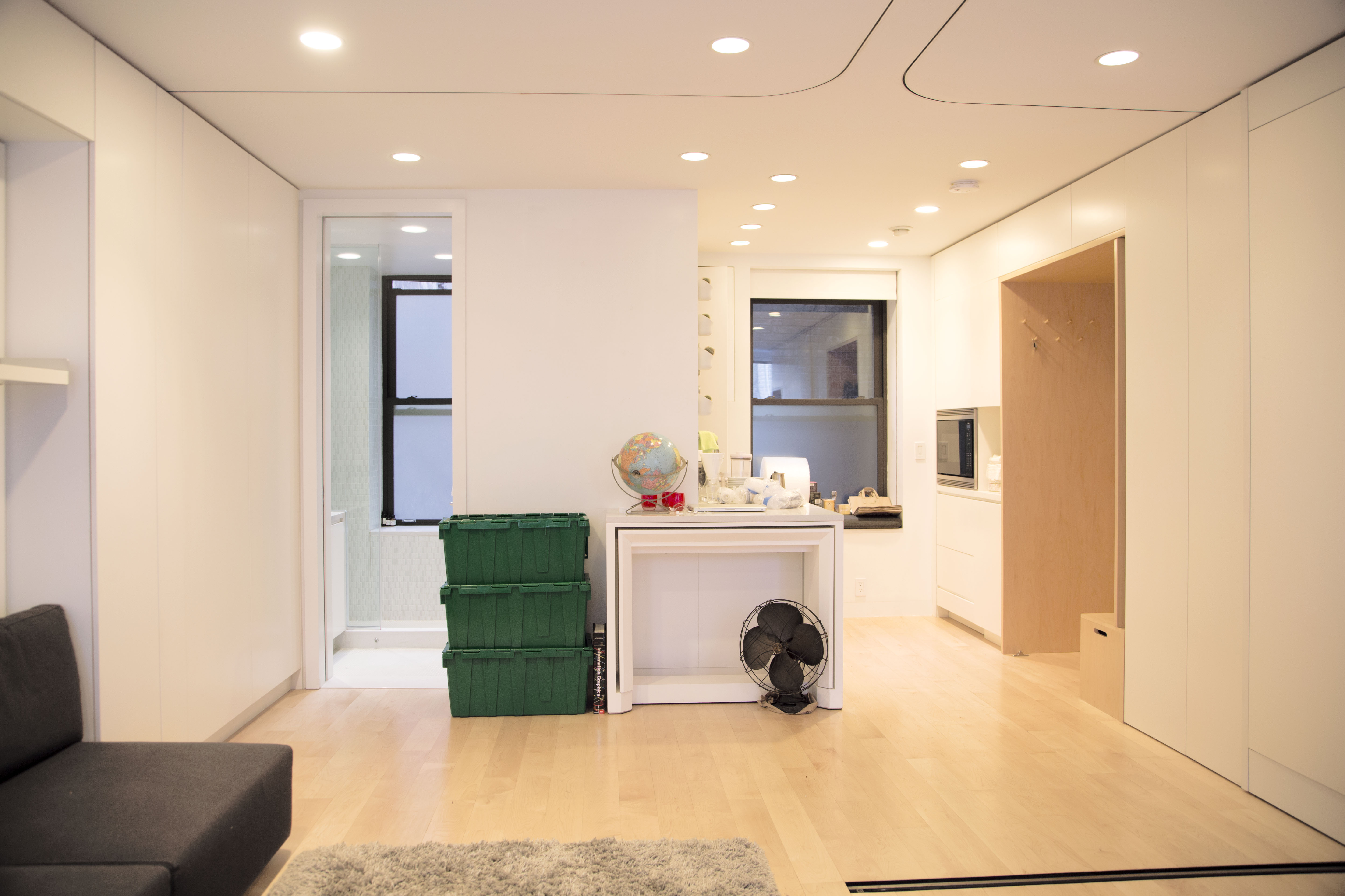 The minimal living room and kitchen inside of Graham Hill's 420-square-foot micro-apartment in SoHo Manhattan.