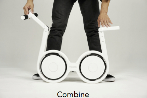 A man is combining the white Impossible folding electric bike.