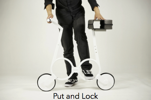 A man is putting the white Impossible folding electric bike into the Put and Lock position.