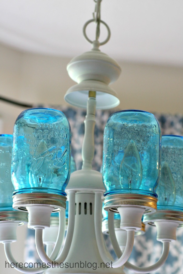 A DIY mason jar chandelier adds charming light to any living room or dining room in a tiny apartment.
