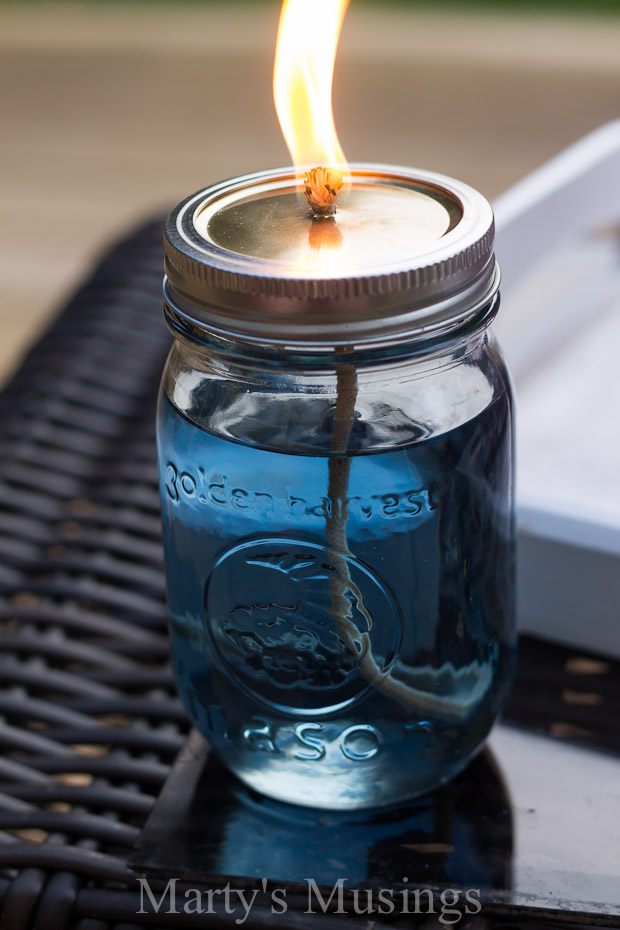 Make a DIY mason jar citronella candle to stop mosquito bites from happening on your tiny apartment's balcony.