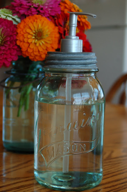 Use a DIY mason jar soap dispenser to wash your hands and save space in your small apartment's kitchen.