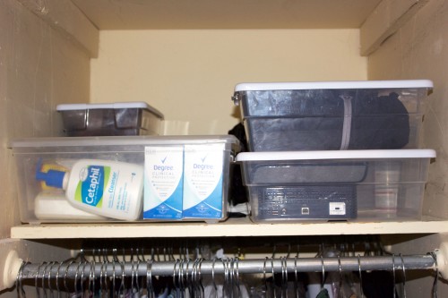 Clear storage containers stacked neatly on a shelf is one sign of an organized bedroom closet.
