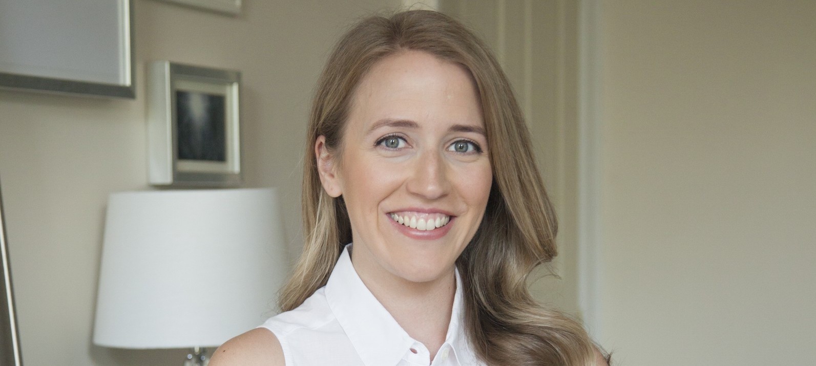 NYC professional organizer Anna Bauer standing in a clean bedroom.