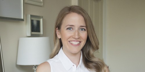 NYC professional organizer Anna Bauer standing in a clean bedroom.