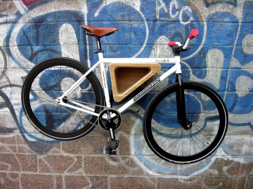 The Bedford Ave Bike Rack by 718 is a triangular bike storage solution made from birch ply and veneer