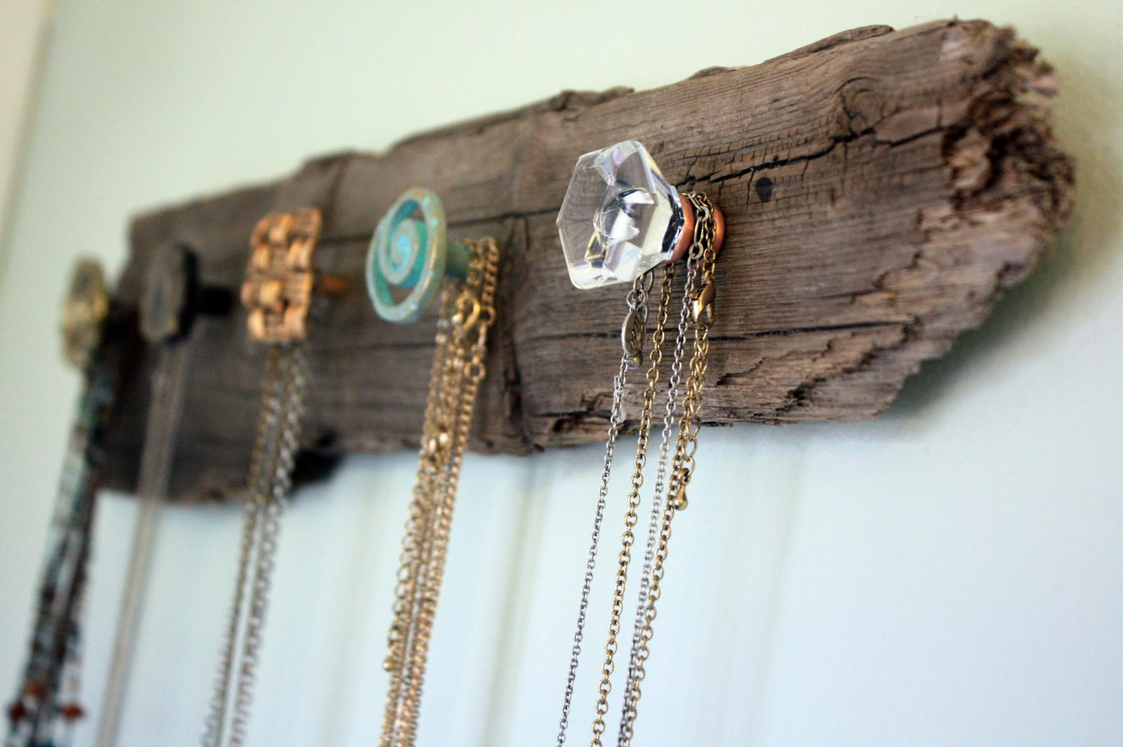 A DIY wood pallet jewelry holder used for necklace storage.