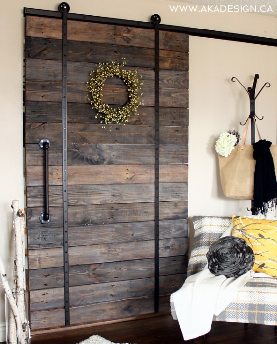 A DIY wooden shipping pallet door used for privacy in tiny apartment rooms.