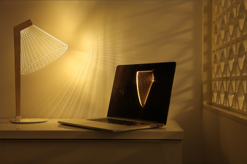 Studio Cheha's 2D/3D DESKi BULBING lamp is on a desk with storage and illuminating a laptop.