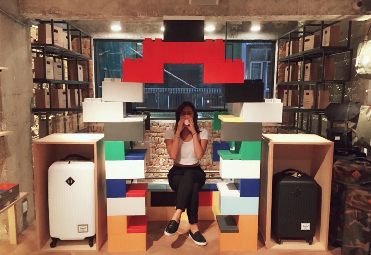 A woman sitting in giant LEGO furniture made of EverBlocks.