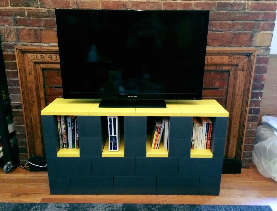 A TV stand with storage made of EverBlocks that resemble big LEGOs.