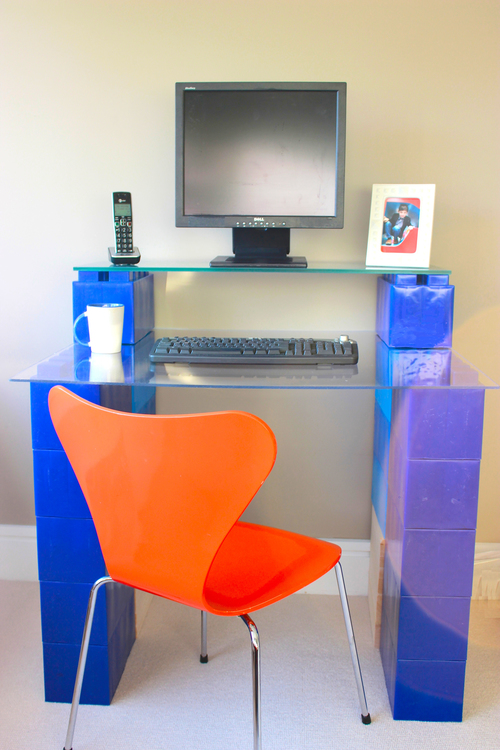 A blue giant LEGO desk built out of EverBlocks.