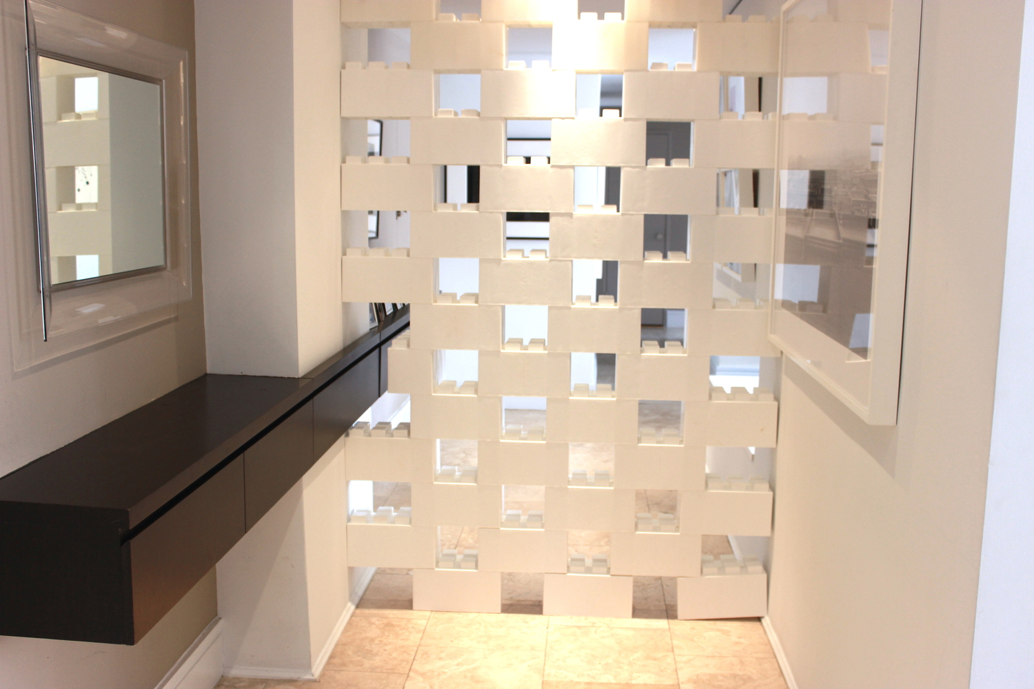 A white divider wall made of staggered EverBlocks, which are basically life-size LEGOs.