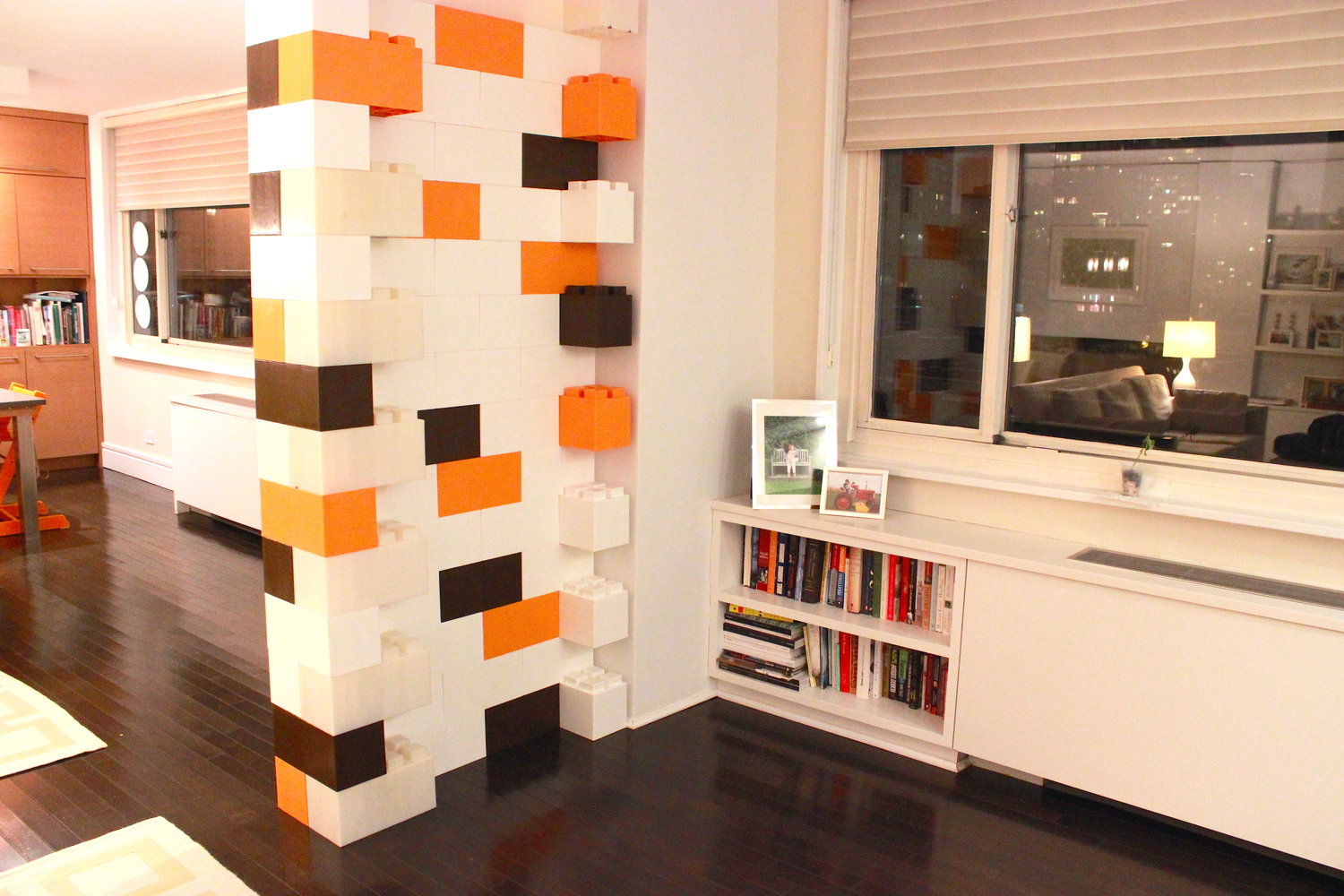 An accent wall made of brown, orange, and white EverBlocks, which look like big LEGO bricks.