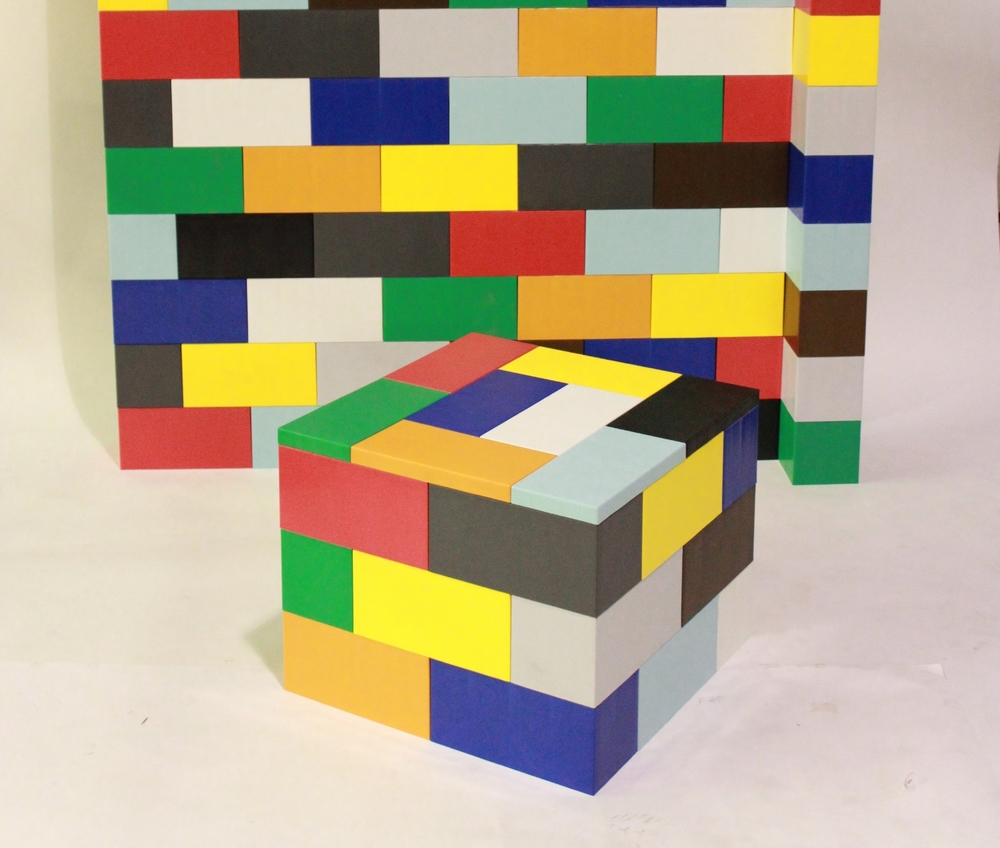 A multicolor wall and cube made of EverBlocks that resemble big LEGOs.