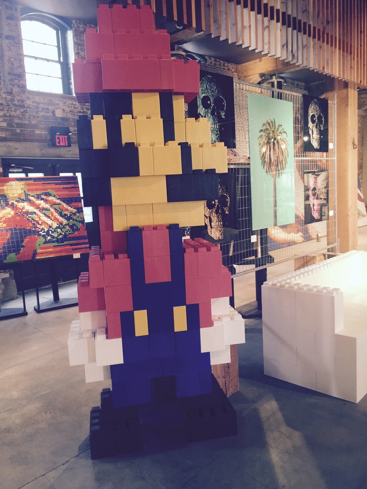 A giant Mario statue made of EverBlocks that look like life-size LEGO bricks.