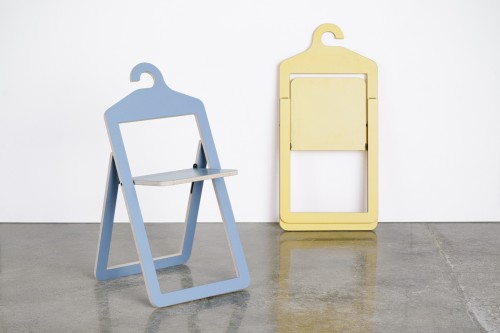 An open marine Umbra Shift Hanger Chair and a folded yellow Hanger Chair that are both designed by Philippe Malouin.