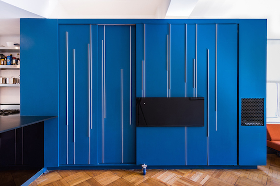 The closed blue space-saving furniture/storage cabinet in the Unfolding Apartment that's located in Manhattan, New York.