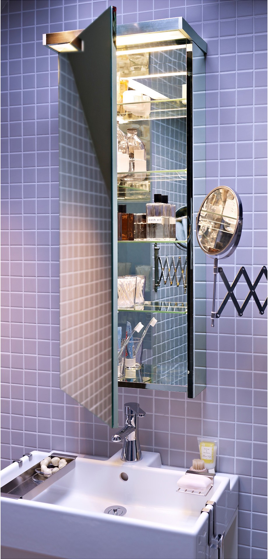 An IKEA GODMORGON, which is a big storage cabinet with four adjustable shelves and a dual-side mirror, is mounted to a tiled bathroom wall.