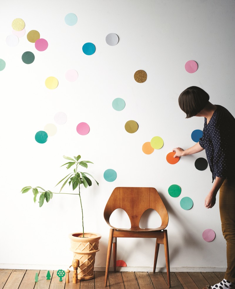 A white wall is scattered with colored dots, making it look like a giant funfetti cake/DIY decoration.