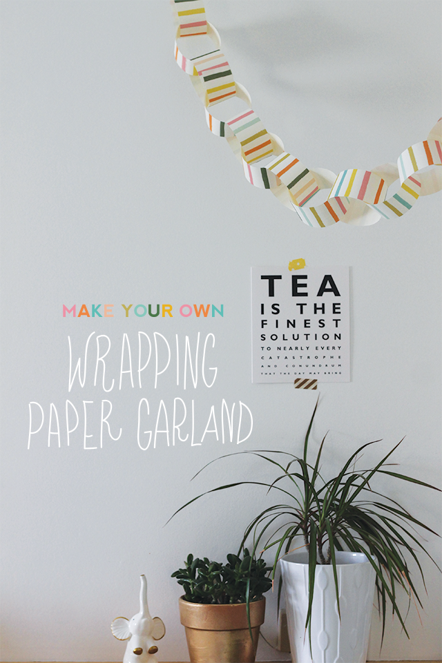 DIY wrapping paper garlands are hanging from a ceiling in front of an eye-exam-resembling white sign that reads "Tea is the finest solution."