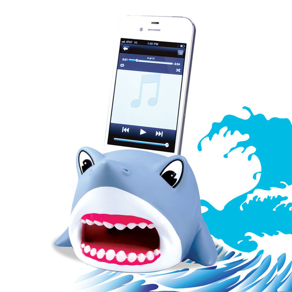 A Shark Powerless Amplifier from DCI Gift is storing a white iPhone 6.