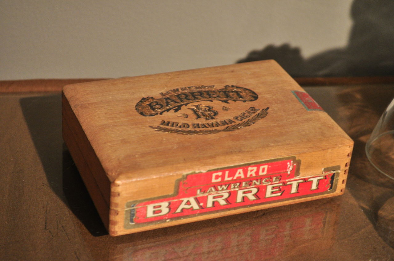 A wooden vintage Claro Lawrence Barrett cigar box that can also be used for jewelry storage.