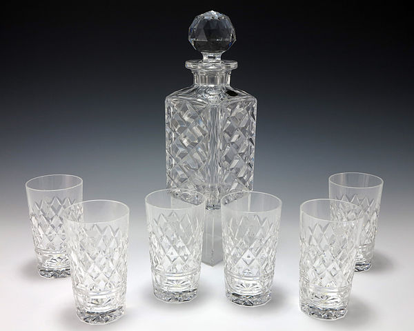 A vintage diamond cut Val St. Lambert crystal whiskey decanter with an etched diamond design and 6 matching glasses.
