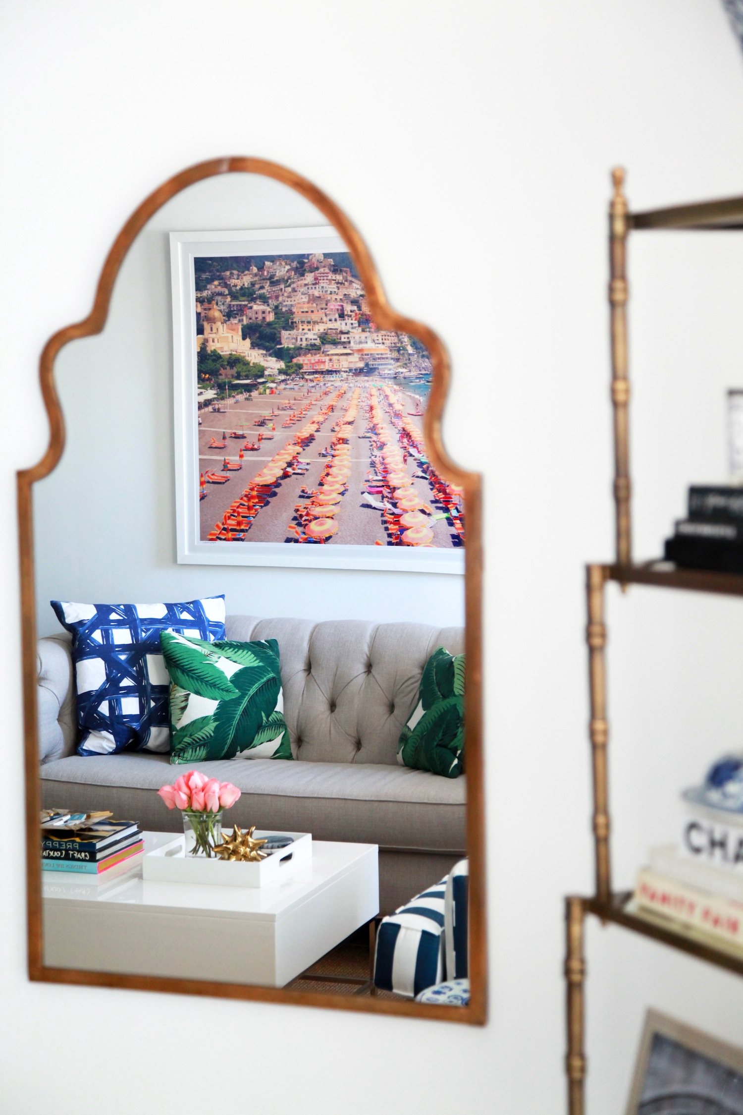 A creative decorating idea to make an apartment feel bigger is to strategically hang mirrors on a wall.