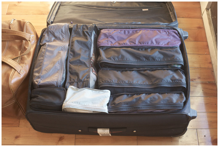 How to move from a house to an apartment: use a suitcase for out of season clothes storage.