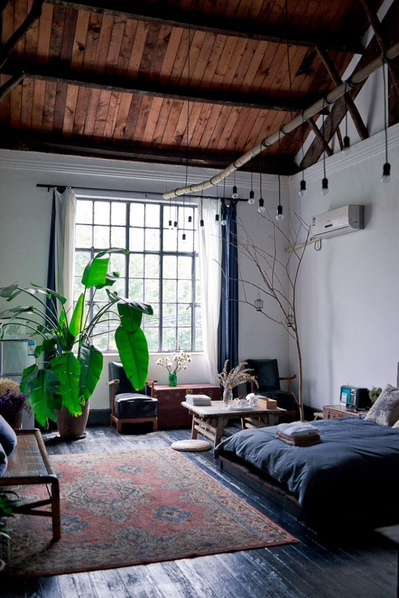 Bedroom-with-large-plants-and-hanging-lights