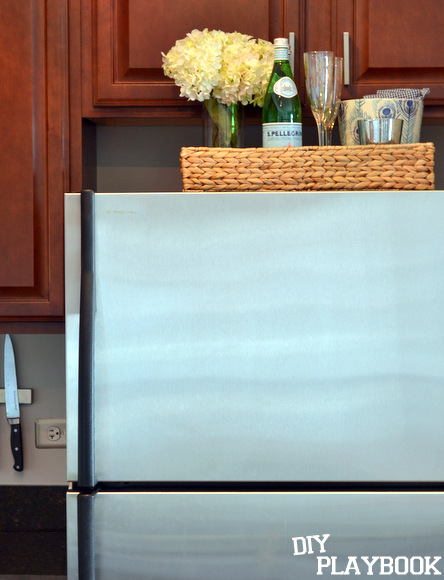 To save space in a small kitchen, put a tray on top for extra storage.