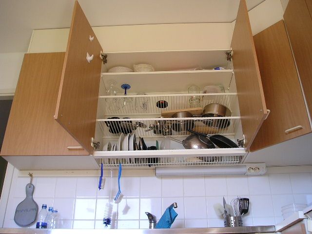 Install wire racks into a cabinet to serve as tiny kitchen storage.