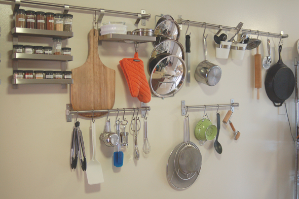 Space-saving wall-mounted S hooks used for kitchen storage in a tiny home.