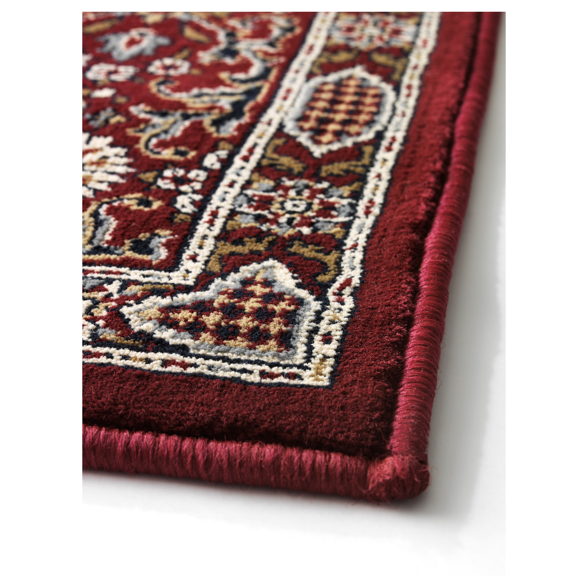 A closeup of a burgundy IKEA Valby Ruta rug.
