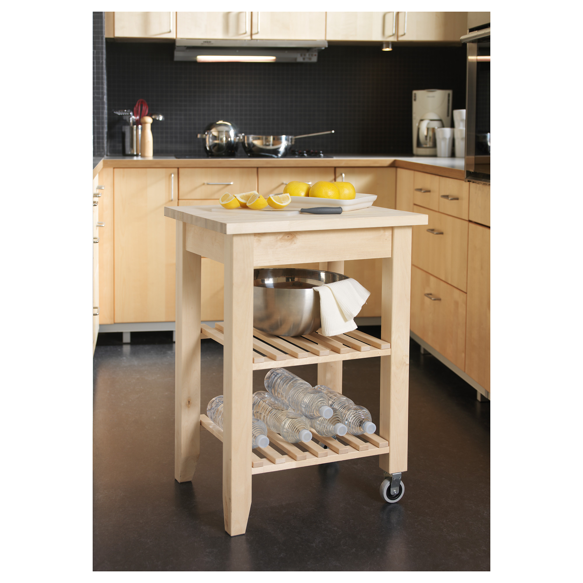 An IKEA Bekvam portable butcher block with wheels is in a clean and organized kitchen.