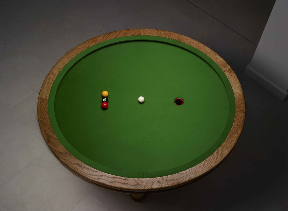 LOOP is a circular space-saving game similar to pool but played with three balls and one hole.