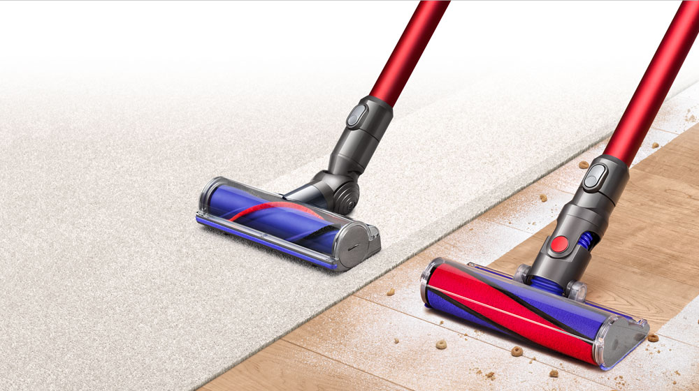 A Dyson v6 absolute sweeping a wooden floor and vacuuming a carpet.