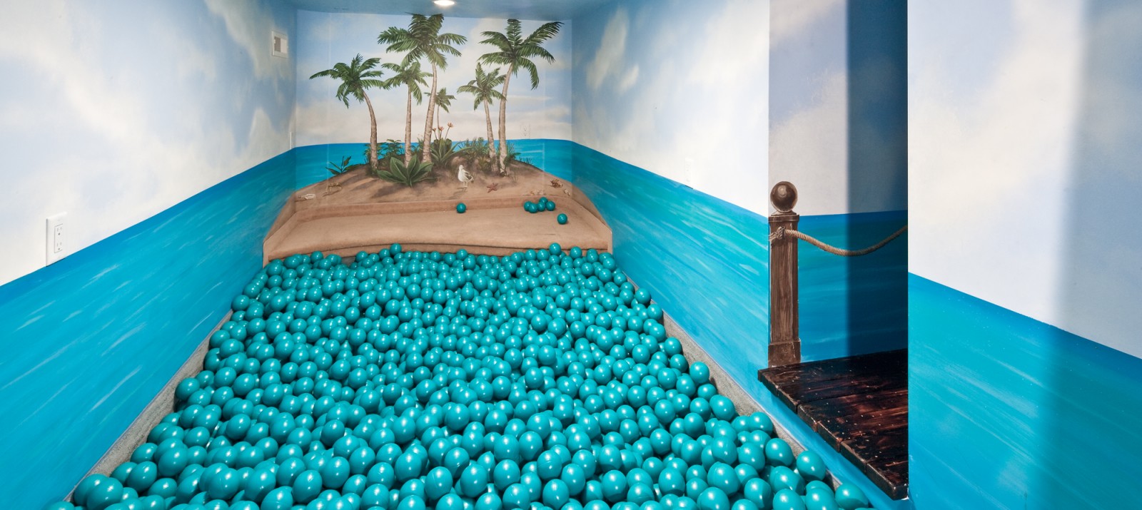 An indoor ball pit that looks like a tropical island.