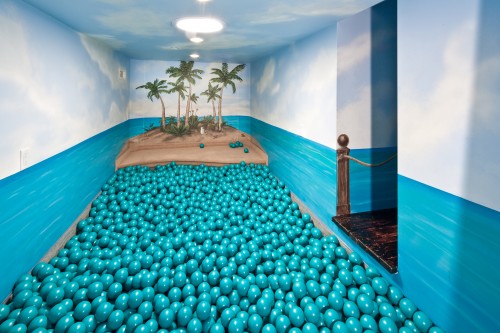 An indoor ball pit that looks like a tropical island.