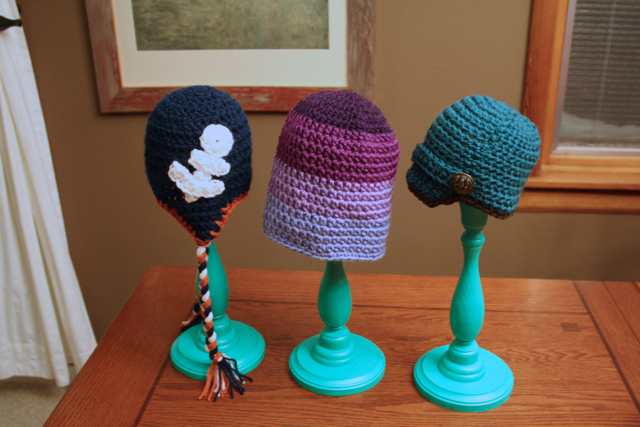 DIY storage for small spaces: winter hats on candlesticks.