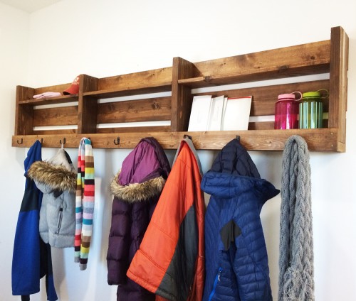 A DIY wood pallet entryway organizer for coats, hats, gloves, scarves, handbags, messenger bags, and backpacks is one of many creative storage ideas for small spaces.