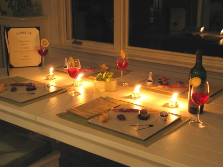 Keep the romance alive with your significant other in a tiny apartment by having a romantic date night at home that includes dinner, candles, and a bottle of wine.